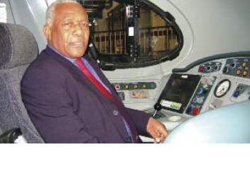 Donald Sewell is photographed sitting on a chair in the driving cab of a train